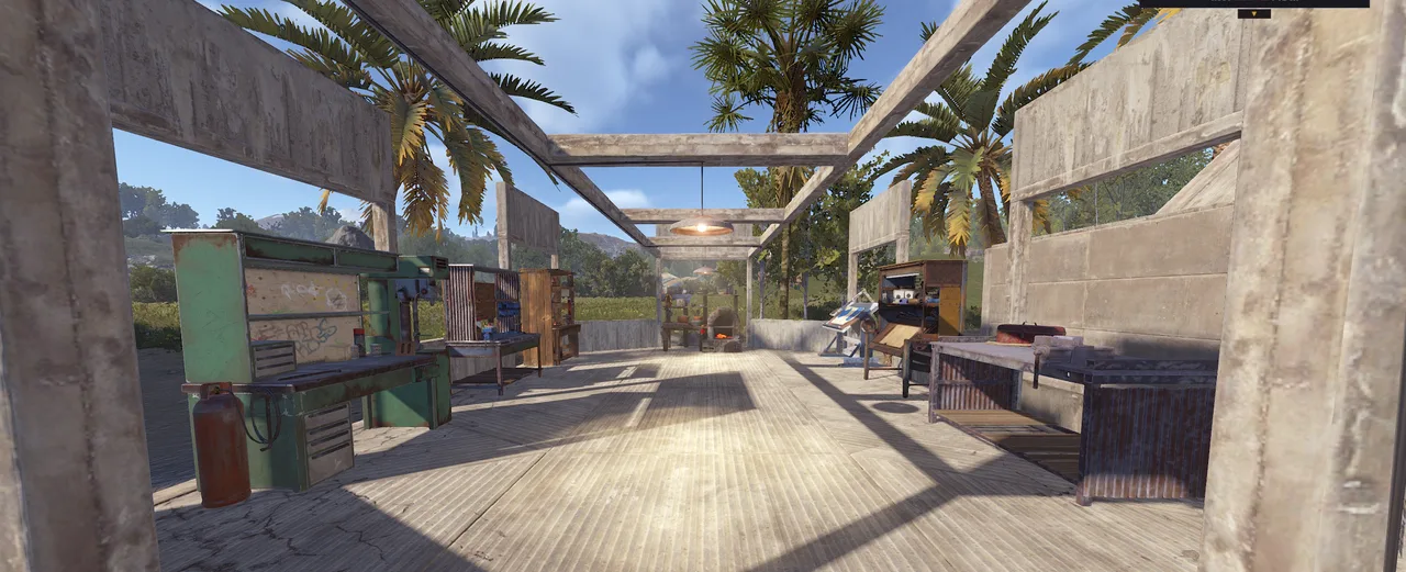 Rust town interior with market stalls, workbenches, palm trees, and open concrete framework.